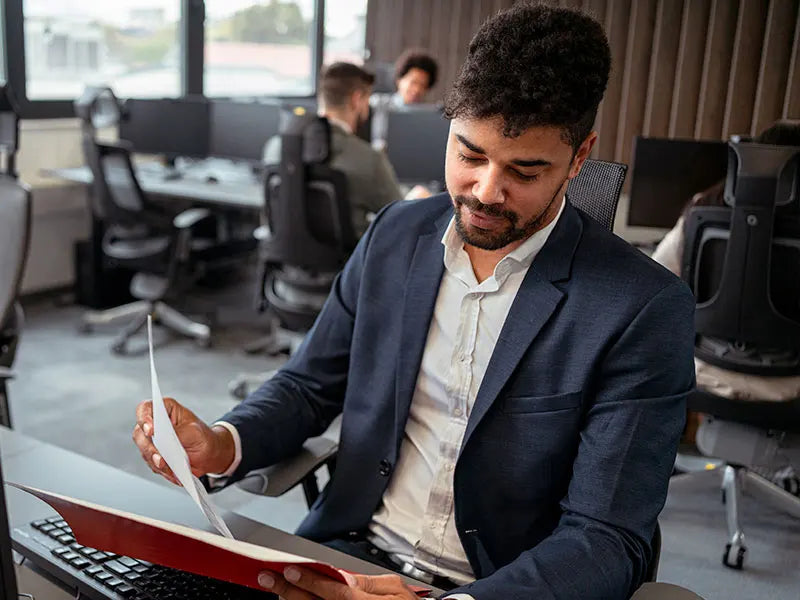 Man sitting at desk reviewing files