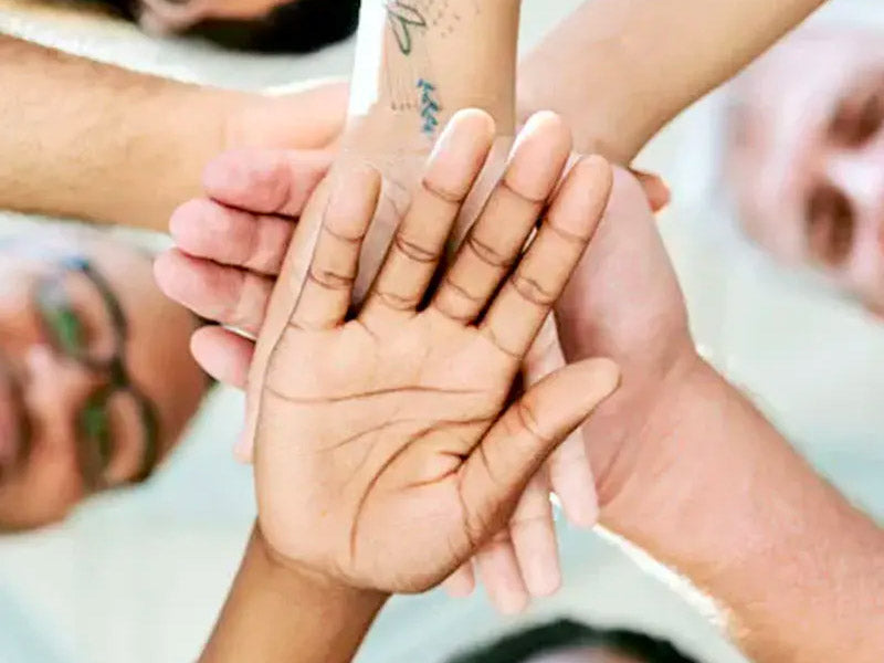 A group of hands meeting in the middle